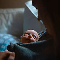 A mother tenderly holds her newborn baby at the hospital.