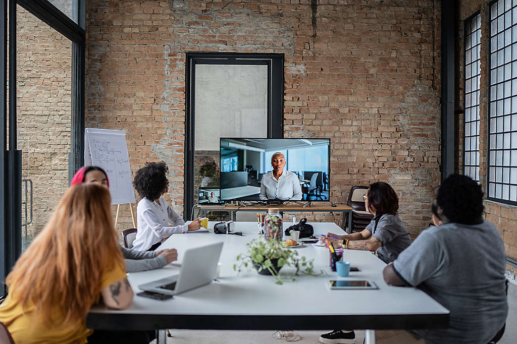 A group of employees watching a group benefits webinar session