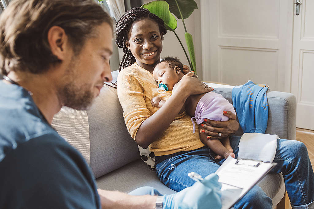 Parents and a newborn visiting their pediatrician