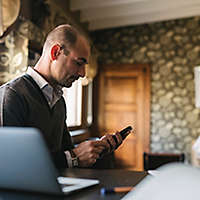 Businessman using a phone in home office