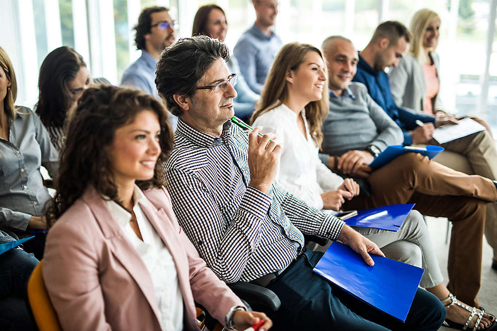 attendees at a conference listening to a session