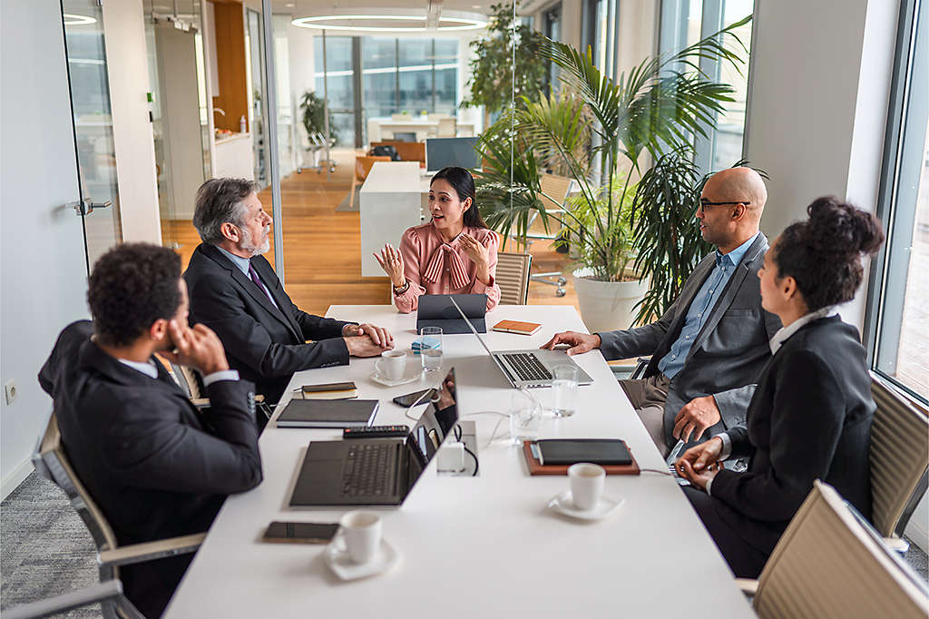 diverse group of employees having business meeting at conference table
