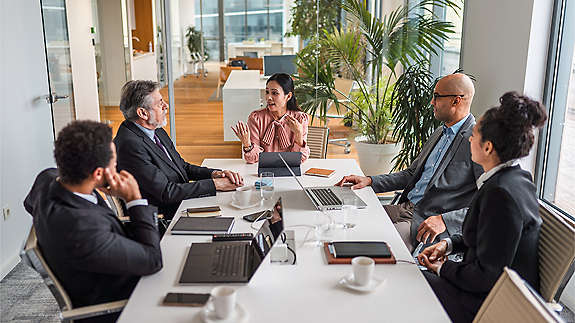 diverse group of employees having business meeting at conference table