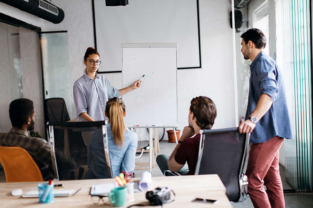 diverse group of employees sit attentively during a financial wellness seminar
