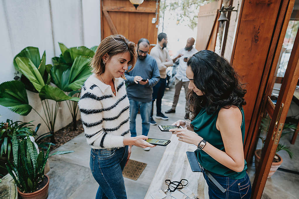 employees at a workplace wellness event engaging with digital health tools