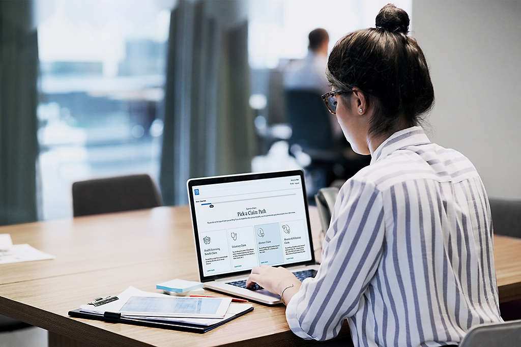 rearview shot of hr professional working on a laptop in an office