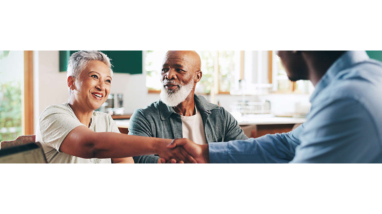 senior couple handshake and meeting with financial advisor