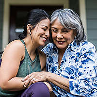 Woman smiling and hugging her mother.