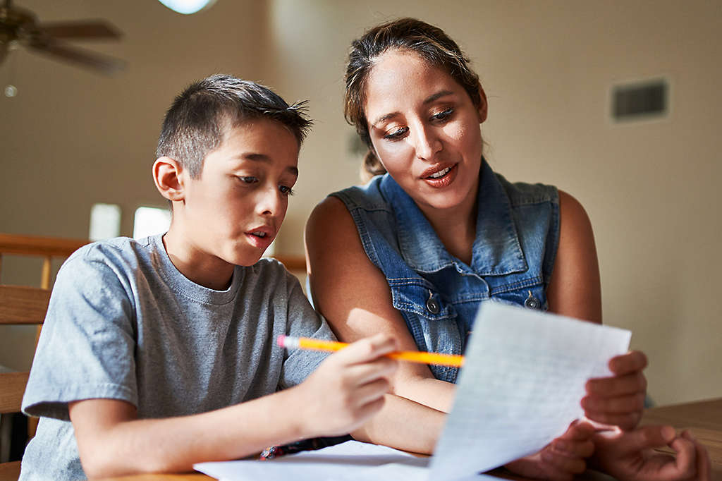 Mother helping son with homework