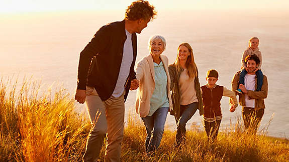 Happy family hiking on the coast