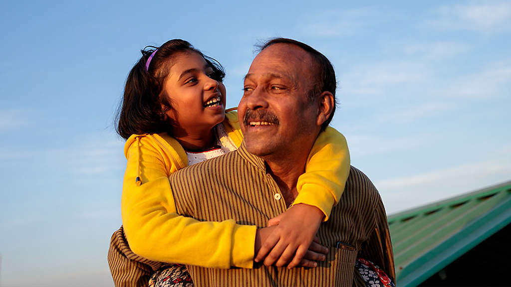 A grandparent warmly embracing a grandchild