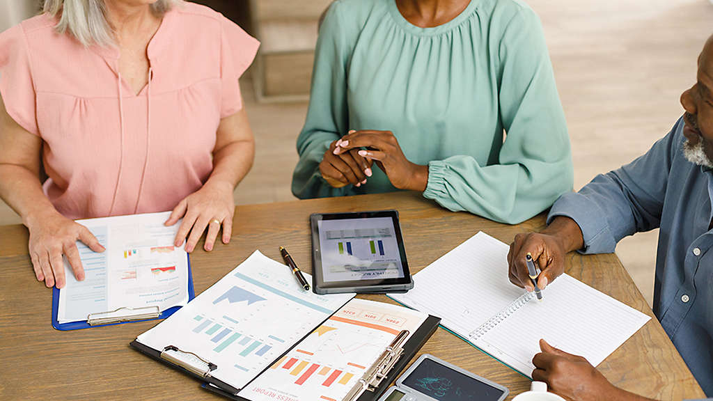 Retirees discussing retirement income strategies with a financial professional.