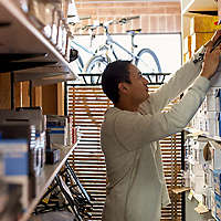 Salesman searching for box on store shelves