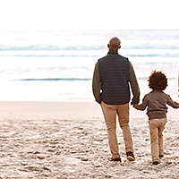 Boy spending time at the beach with his grandfather and father