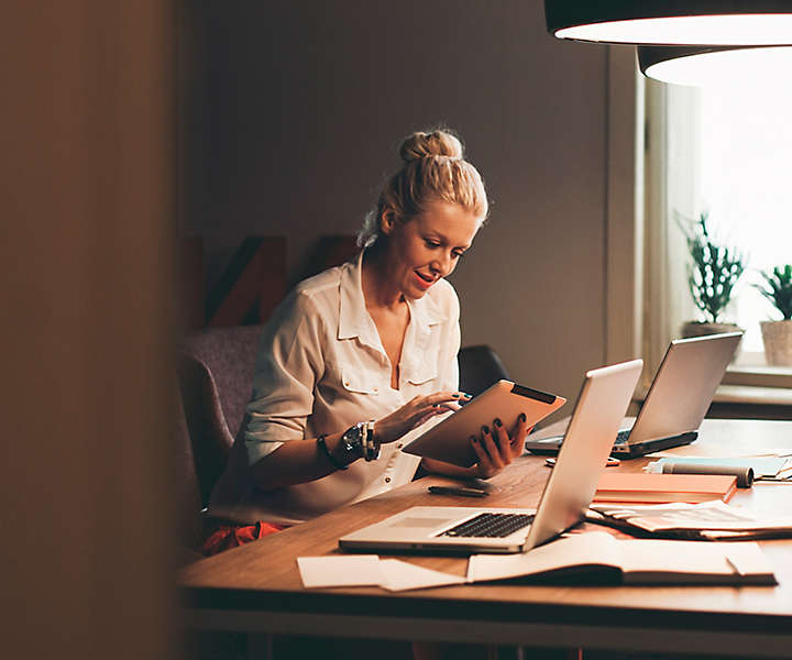 Woman sitting down writing on paper