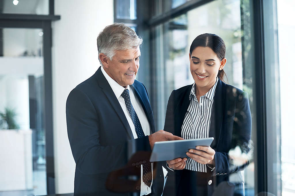 Shot of two businesspeople working together on a digital tablet in an office