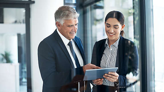 Shot of two businesspeople working together on a digital tablet in an office