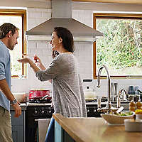 Couple cooking together in kitchen