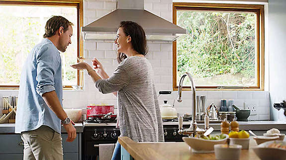 Couple cooking together in kitchen
