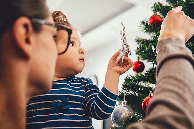 Family decorating a tree