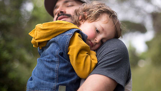 Father holding young son
