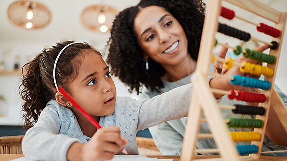 Teacher doing crafts with young girl