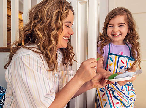 A woman playing with her young daughter