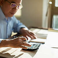 Senior man calculating finances