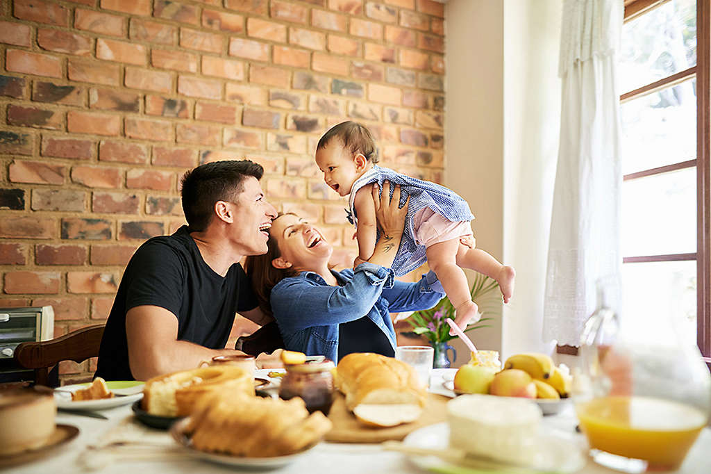 Shot of a parents having fun with their baby girl at breakfast table indoors