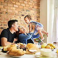 Shot of a parents having fun with their baby girl at breakfast table indoors