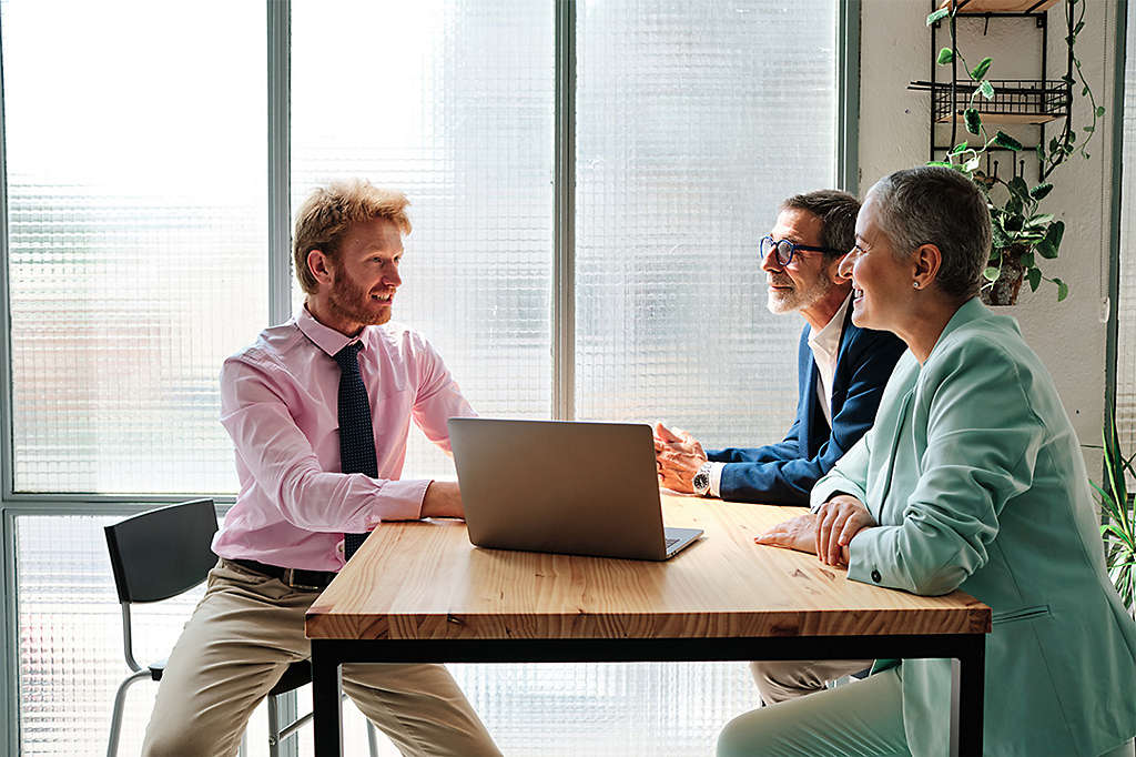 A financial advisor meeting with clients