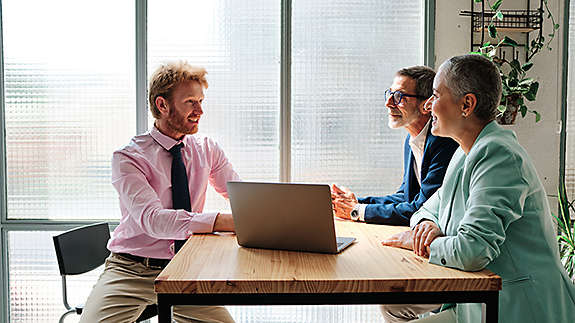 A financial advisor meeting with clients
