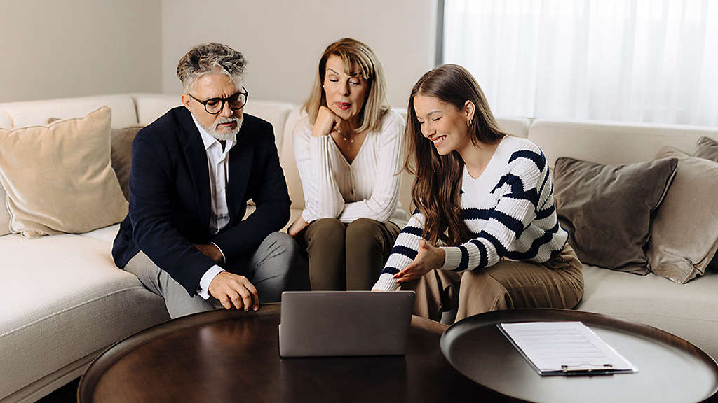 Senior couple talking with female financial or real estate advisor