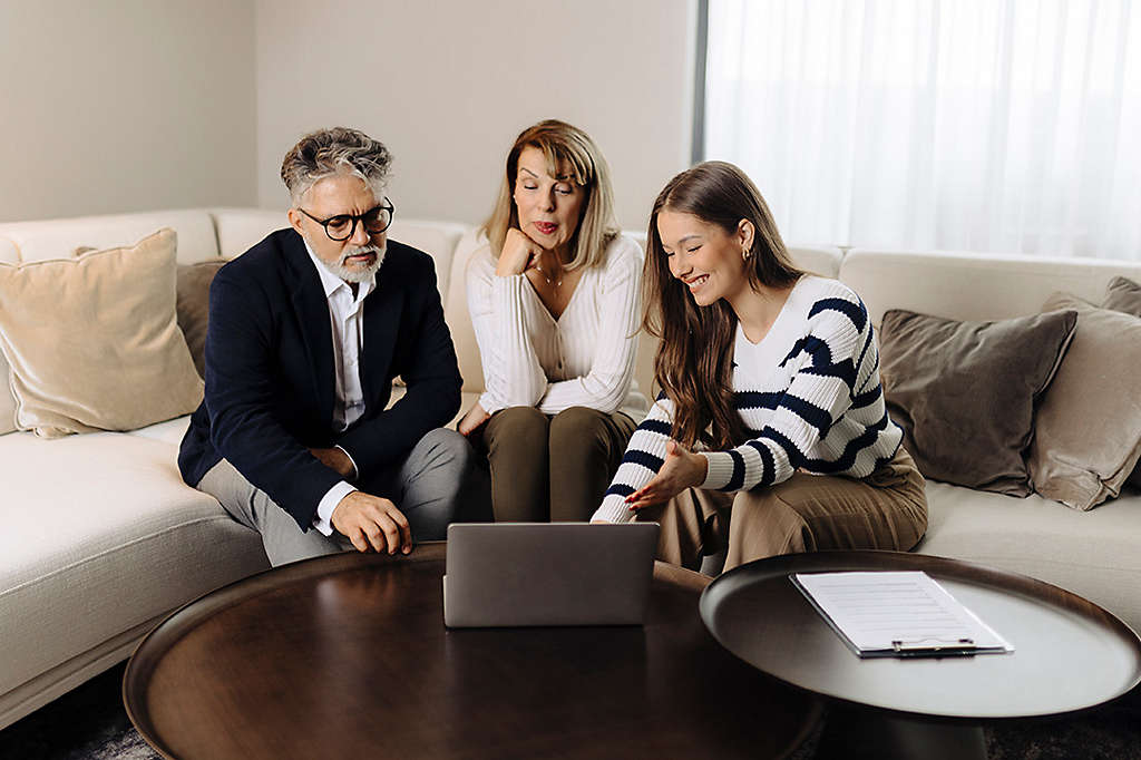 Senior couple talking with female financial or real estate advisor