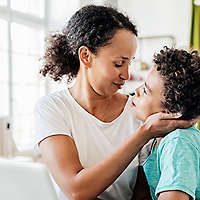Mother and son together at a table.