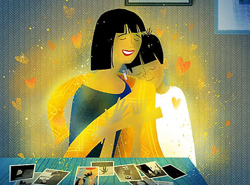 Illustration of a parent being embraced by their child at a table covered with photos