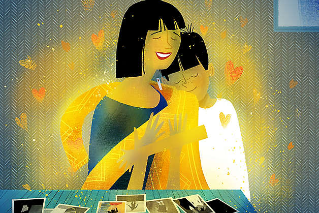 Illustration of a parent being embraced by their child at a table covered with photos