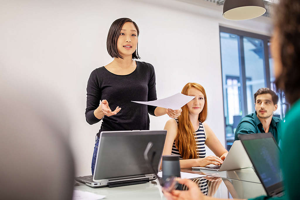 Employee speaking during a meeting with coworkers