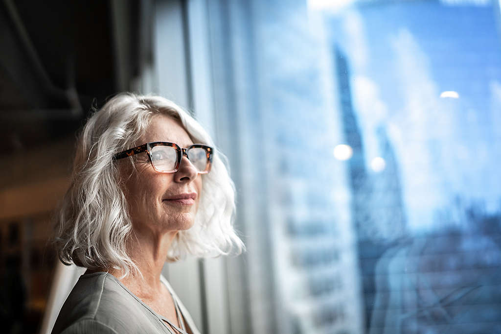 Mature businesswoman looking out of window