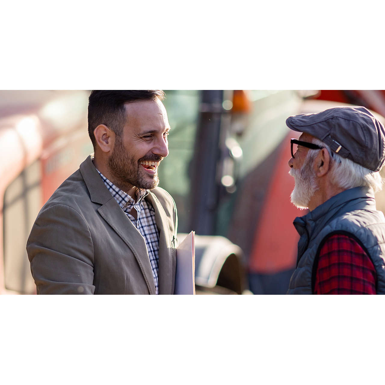 Bank agent and farmer shaking hands on farm