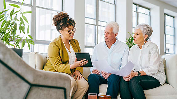 A finance agent reviewing options with two older people