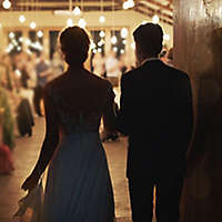 Married couple walking into their reception