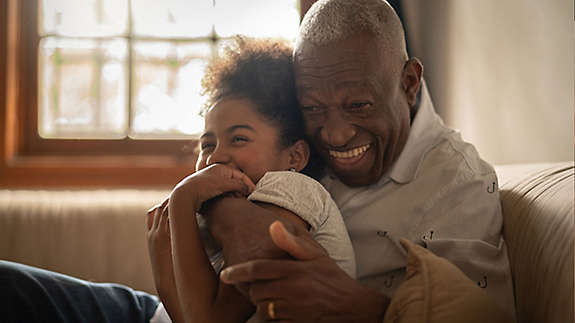 Grandfather hugging his granddaughter