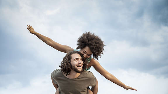 Husband giving wife a piggyback