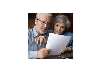 senior couple looking at a paper