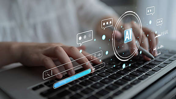 A person typing on a keyboard with an AI symbol