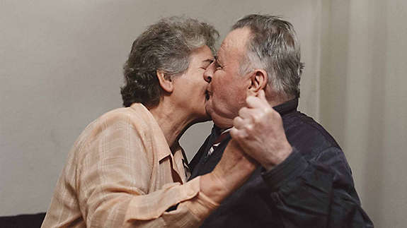 An elderly couple embracing, knowing their future is secure.