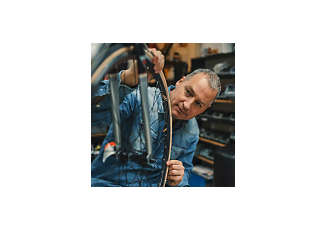 man doing repair work on bike wheel