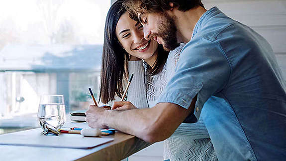 A couple happily doing finances together