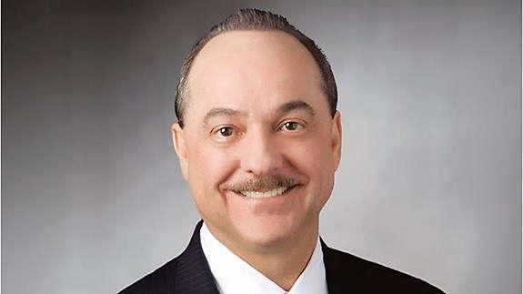 headshot image of Ralph de la Vega